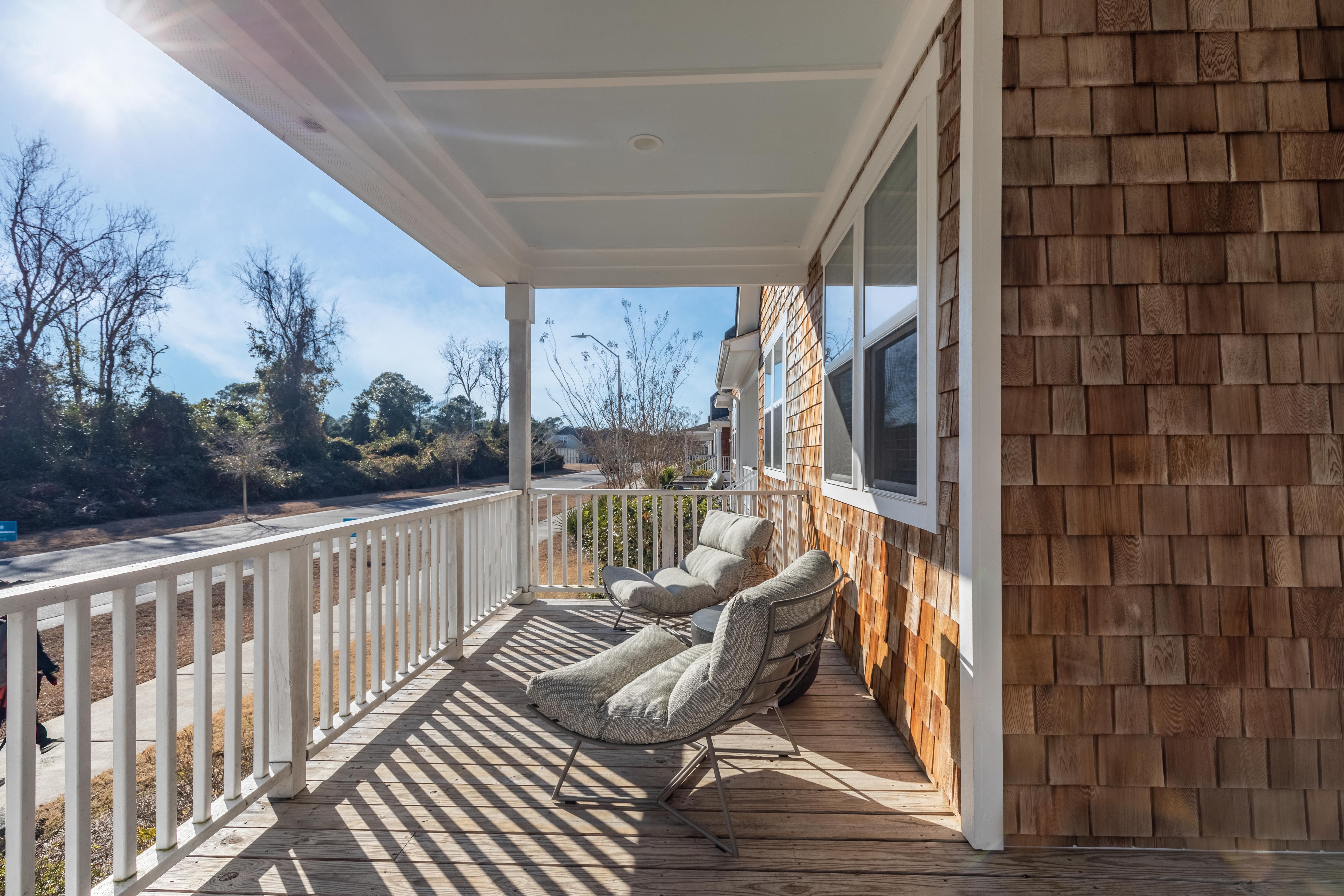 Wilmington NC Apartments - Myrtle Landing - Front Porch with Wood-Style Flooring Surrounded by a White Wooden Fence